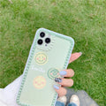 Green iPhone case with geometric smiley face design and polka dot frame on a TPU back cover.