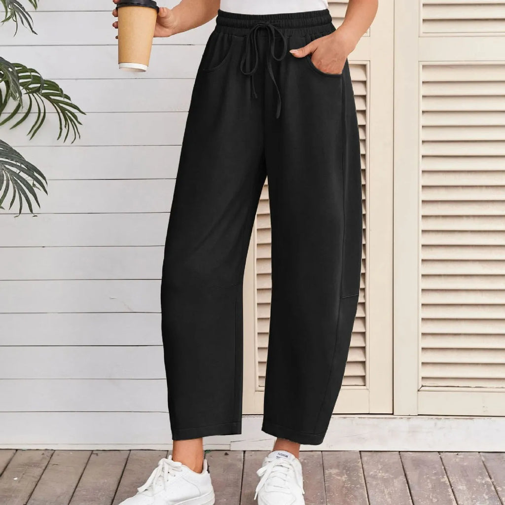 Loose cotton cropped sweatpants with drawstring waist in apricot colour showing street fashion styling