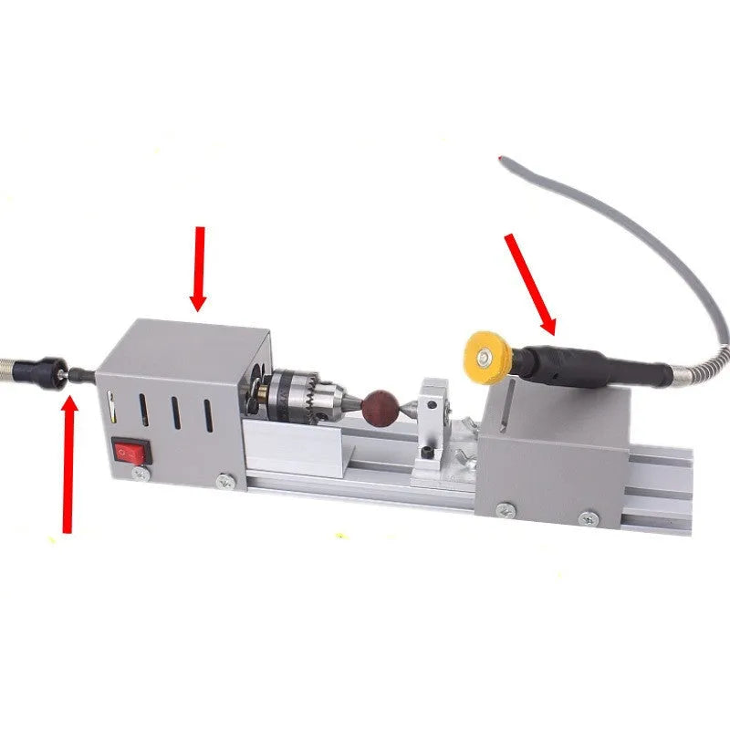 Silver metal mini manual woodworking lathe on a benchtop with carving tools