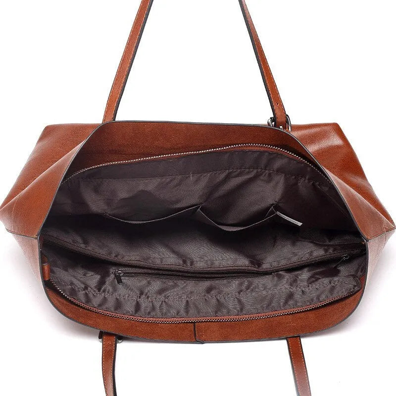 Brown waxed cowhide leather ladies crossbody handbag shown open, revealing internal organiser pockets.