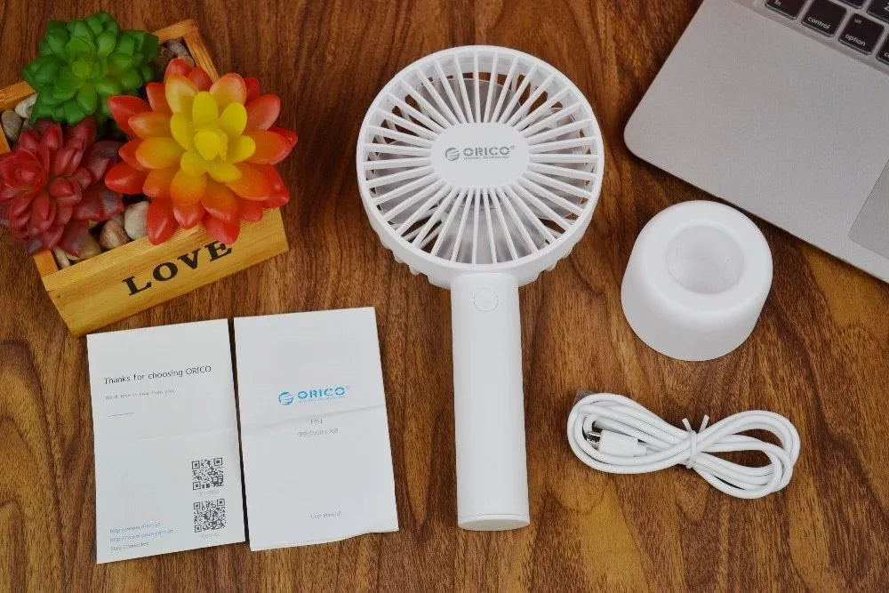 White ORICO FH1 portable USB rechargeable desk fan with three speed buttons and a compact design.