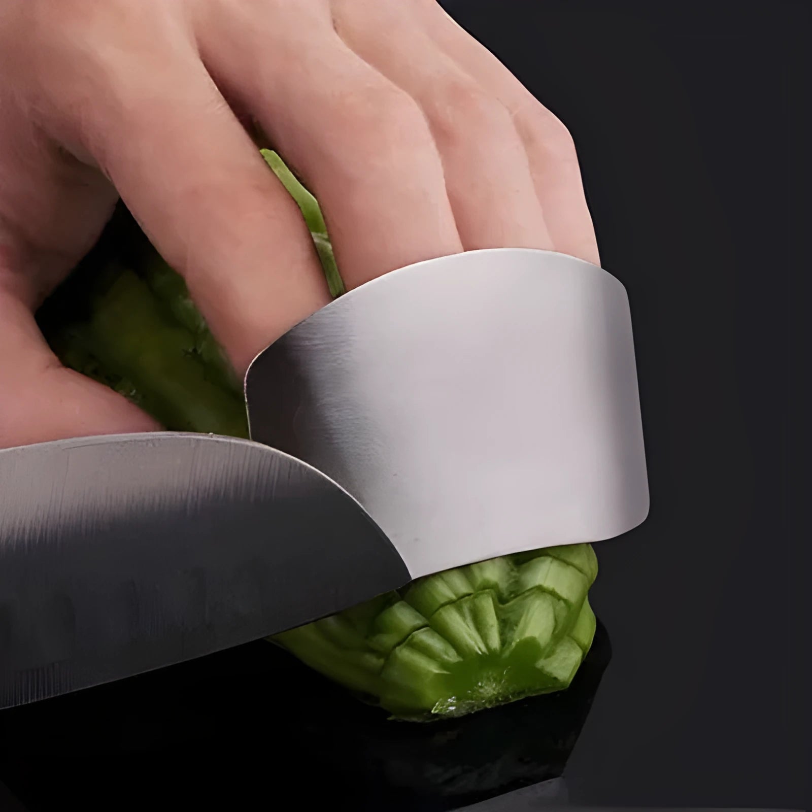 Stainless steel hand guard for finger protection during vegetable cutting.