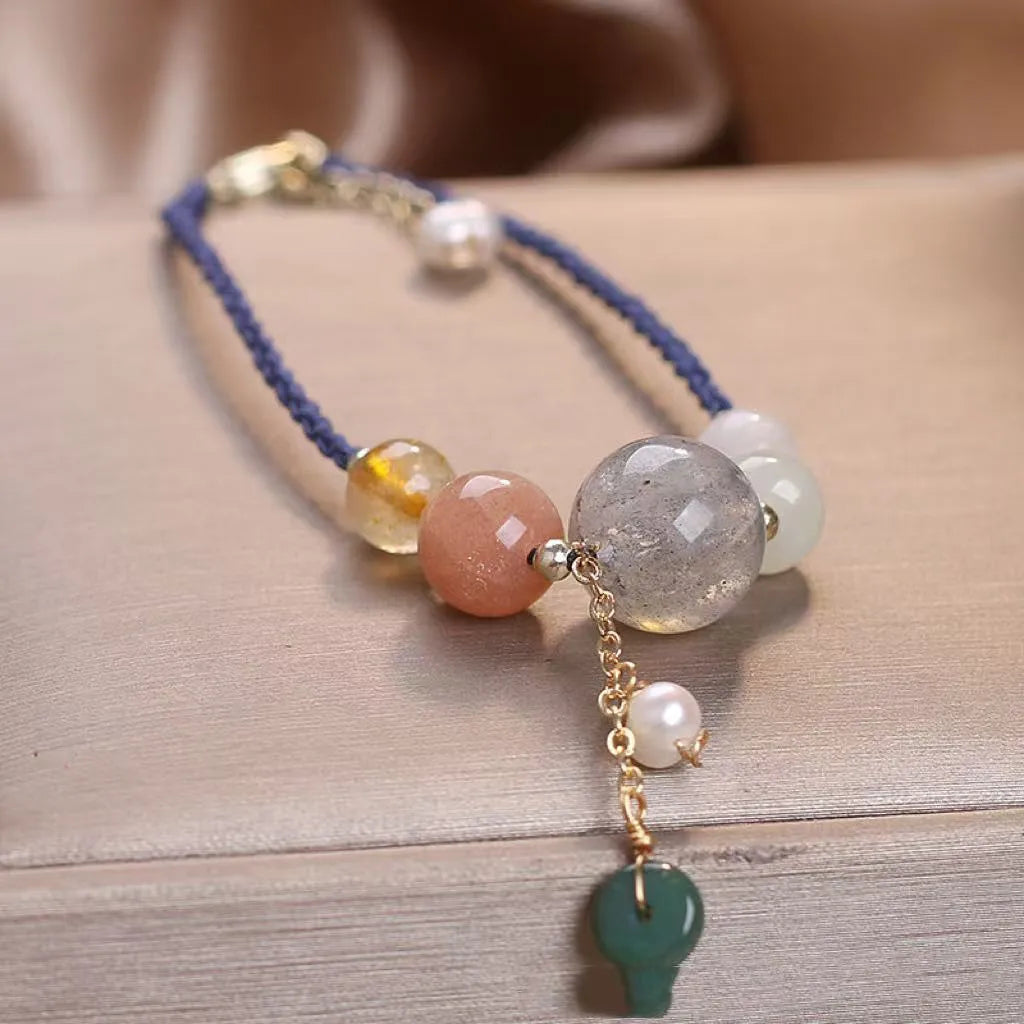 Hand-woven crystal and sequin bracelet with metal buckle clasp in red, blue, or green.