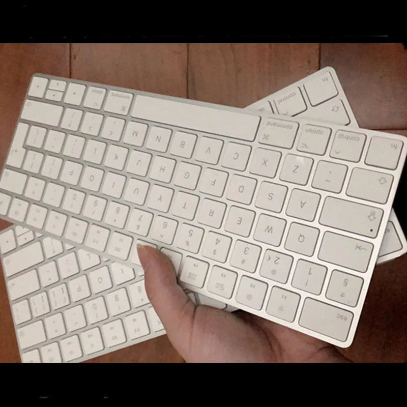 White Apple G6 Bluetooth wireless keyboard with ultra-thin metal casing on desk