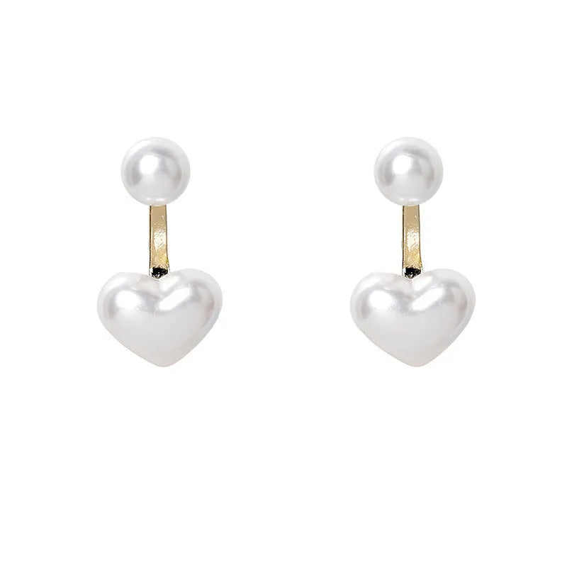 Close-up of a women's heart-shaped alloy stud earring with electroplated finish and central gemstone inlay.