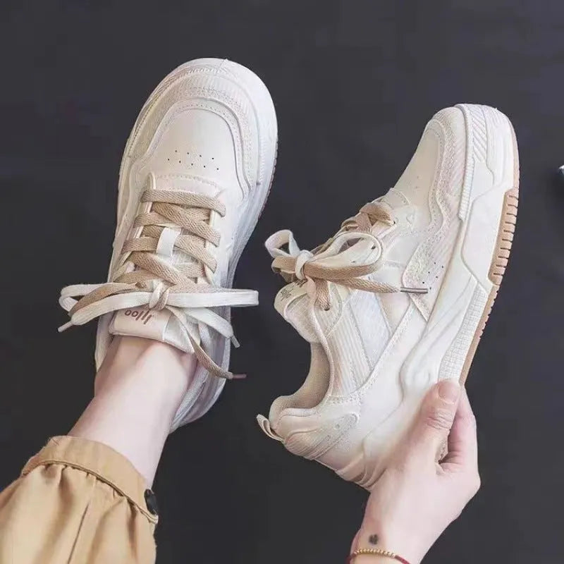 Pink and beige low top sneakers with rubber soles and height-increasing design