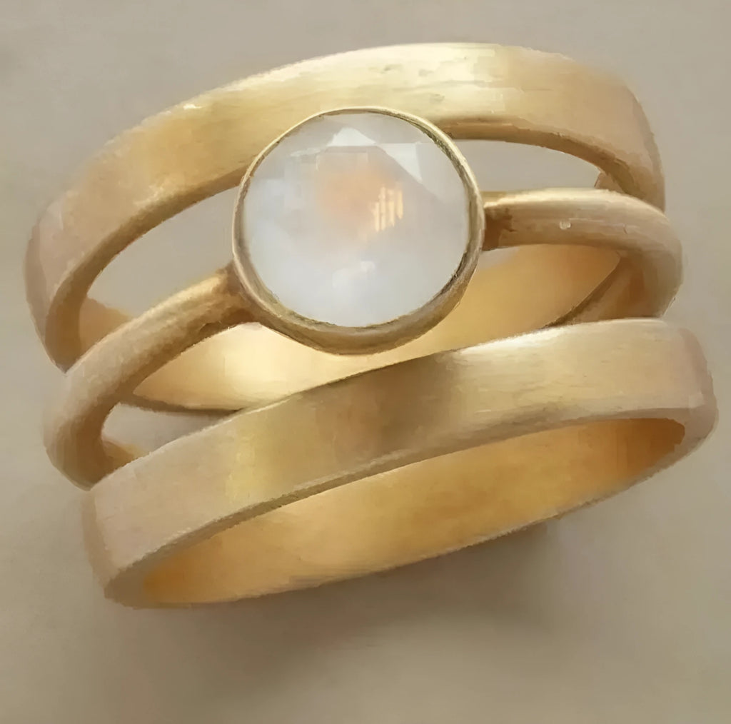 Gold-plated geometric ring with hollow micro-inlaid white chalcedony on titanium steel band
