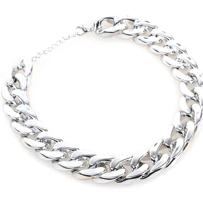 Geometric shaped gold colour dog collar with chain links and buckle on a white background.