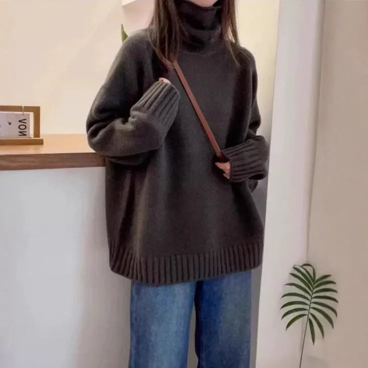 Women's loose thick turtleneck sweater with a curled pile collar in a solid colour.