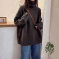 Women's loose thick turtleneck sweater with a curled pile collar in a solid colour.