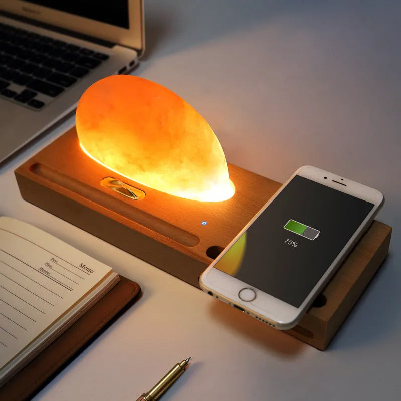 Natural crystal salt lamp on a beech wood base with integrated wireless phone charging pad.