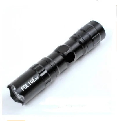 Small black aluminium LED mini flashlight with strong beam, shown next to a AA battery for scale.
