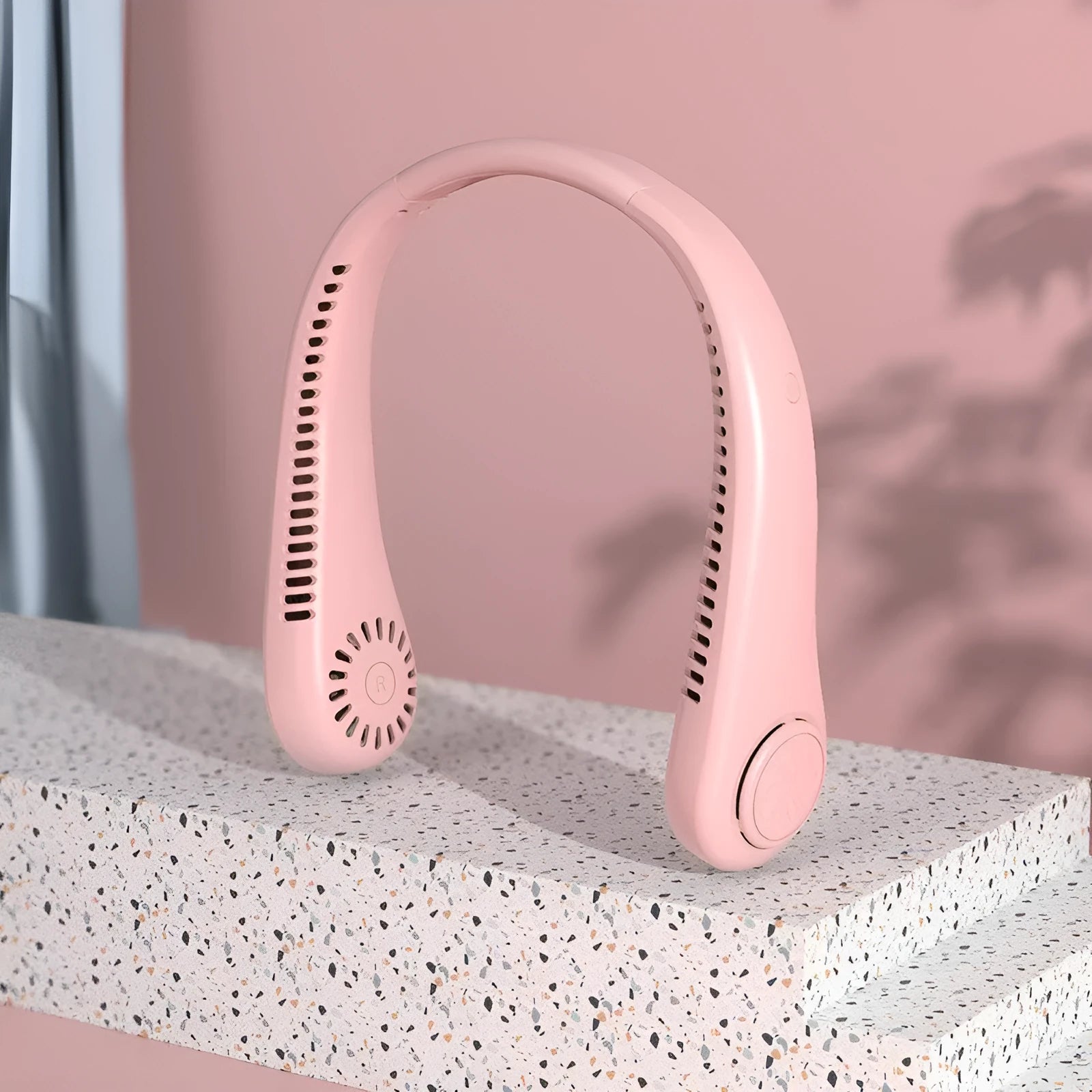 Pink bladeless neck fan with USB charging port and adjustable speed controls