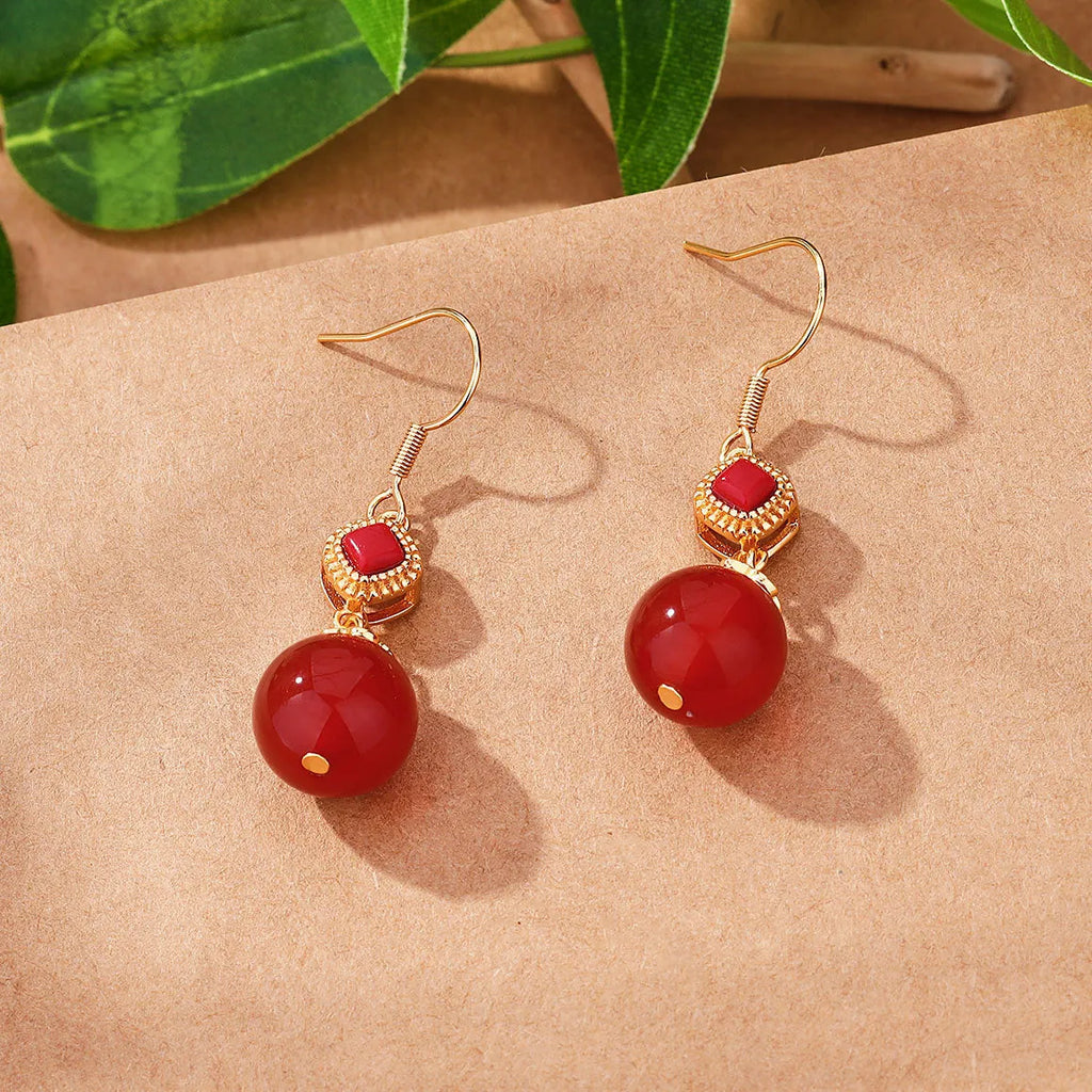 Geometric copper earrings with round red agate beads and silver jasper inlay.