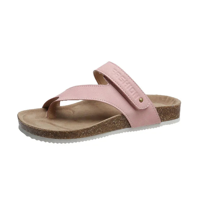 Flat toe ring flip-flops in blue with a thick foam sole on a wooden floor.