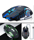 Black and white wireless silent mouse with six buttons on a desk next to a laptop