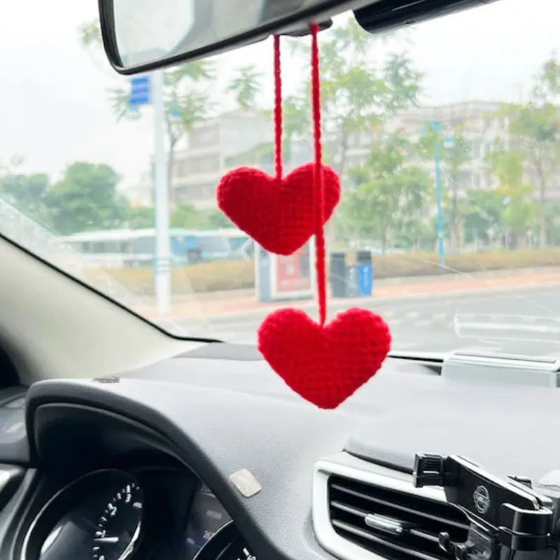 Green and white knitted wool car plant decoration basket with white hanging cord.