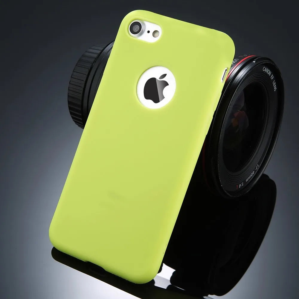 Plain soft silicone TPU phone case for iPhone in a candy colour on a table.