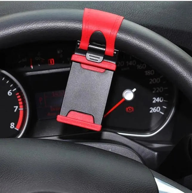 Black steering wheel phone holder mounted showing elastic clip and silicone phone padding