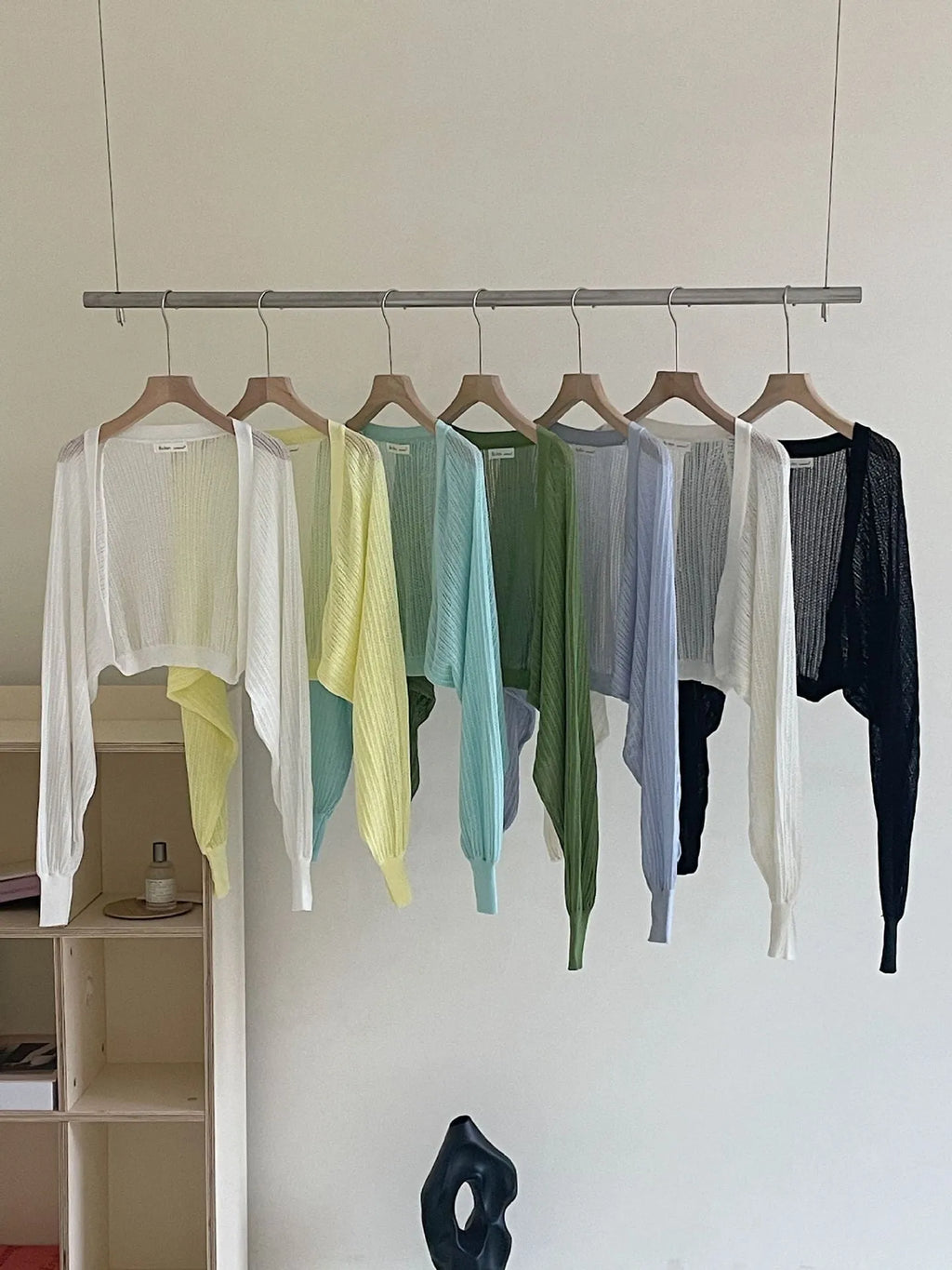Women's white blouse with long, loose lantern sleeves featuring hollow-out details.