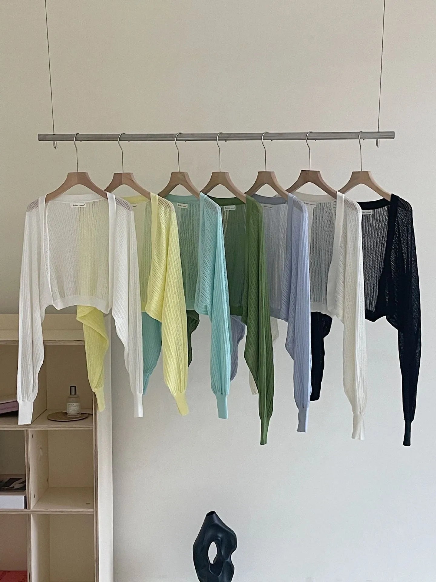 Women's white blouse with long, loose lantern sleeves featuring hollow-out details.
