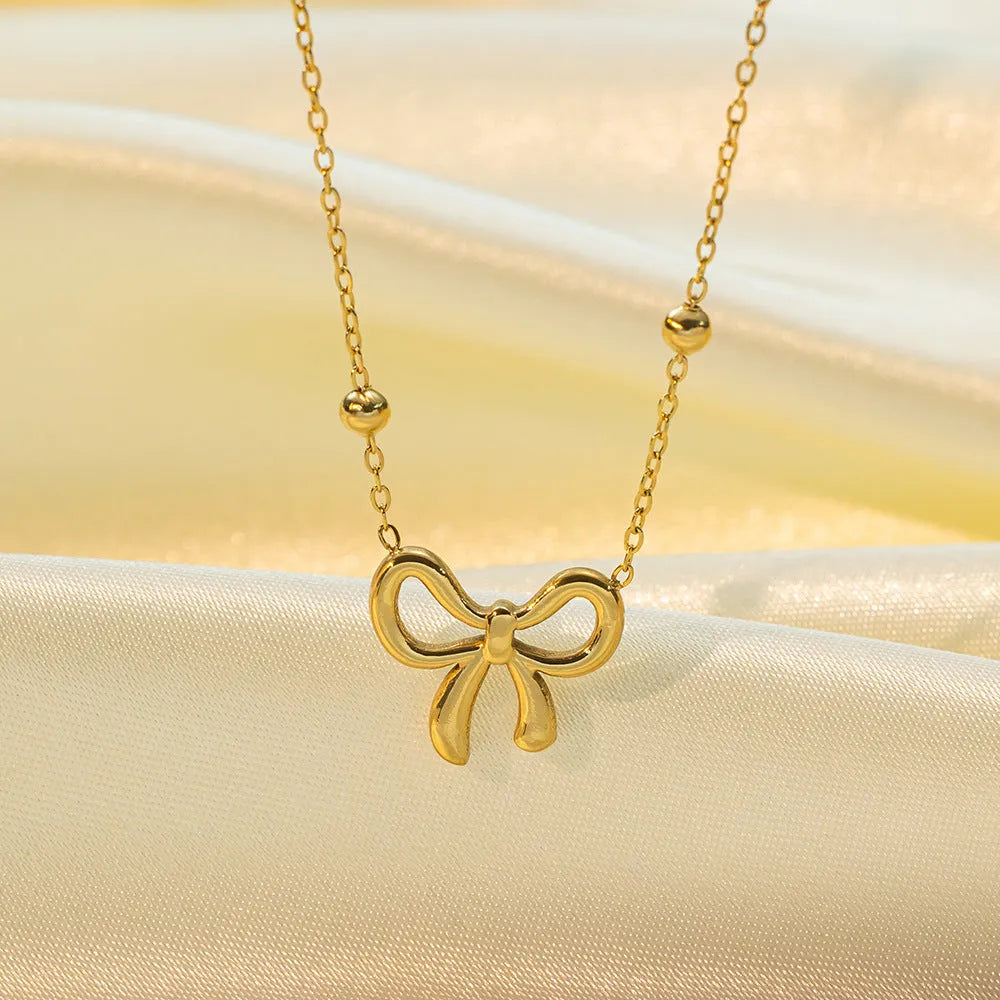 Gold electroplated bow necklace for women with titanium steel chain and adjustable length