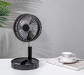 Black telescopic folding fan shown in both extended and collapsed positions, with USB ports visible for charging.