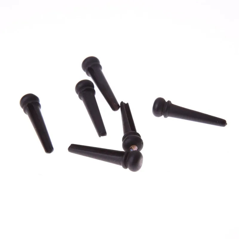 Six ebony folk guitar string nails with 5.3mm bayonet diameter and matt black finish