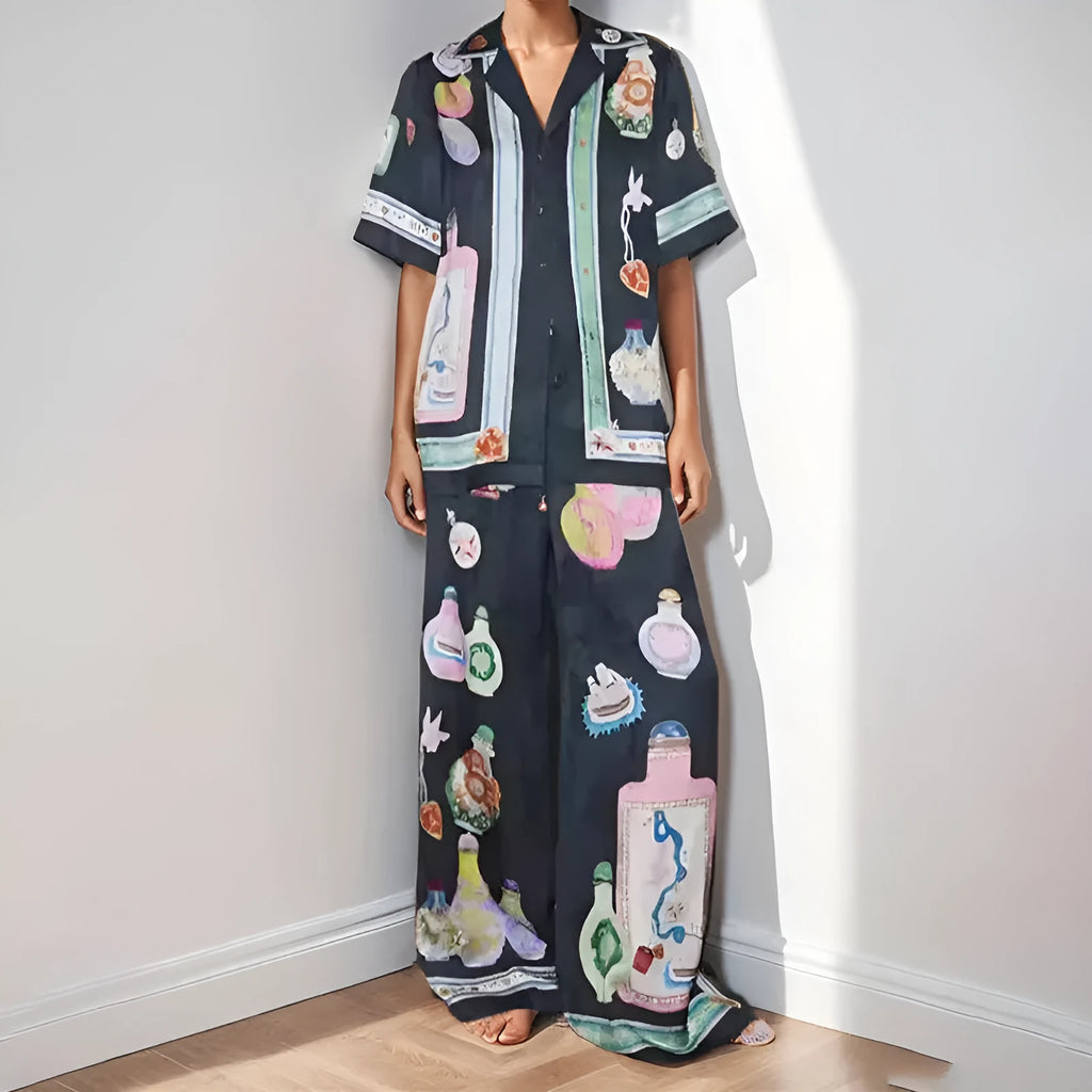 Women's black casual matching set with cartoon animation print, featuring a cardigan sleeve top and trousers