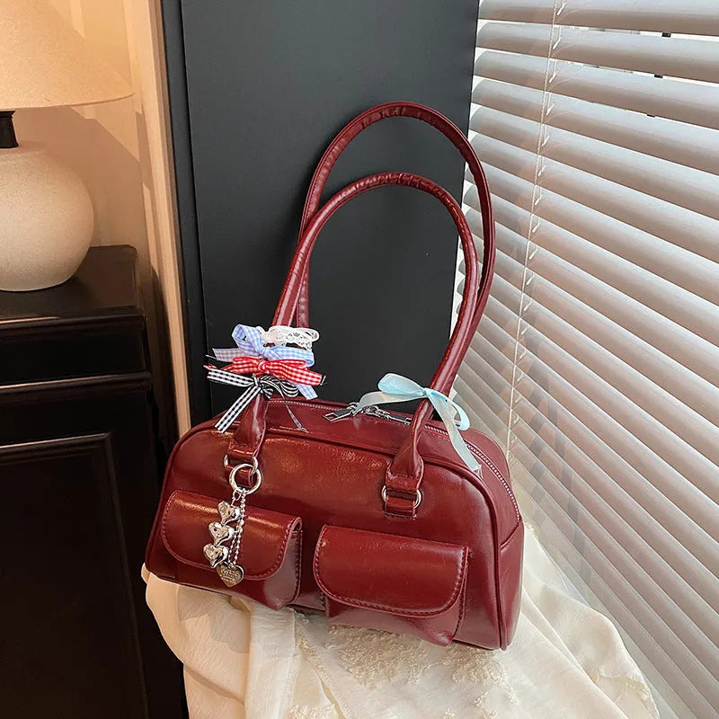 Retro one shoulder underarm pillow bag in PU leather with flap closure and double strap in black brown or red colour options