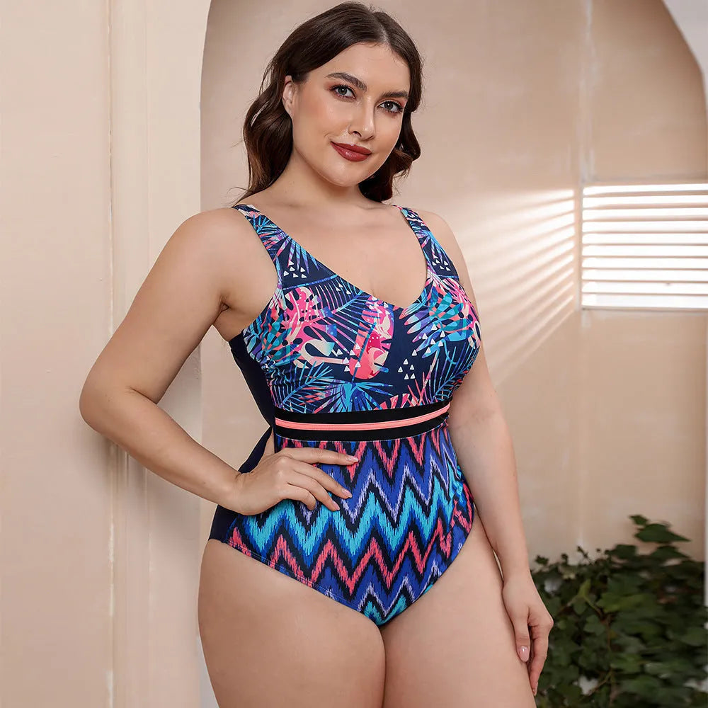 Blue printed one-piece swimsuit with spaghetti straps on a model, showing striped vest design.