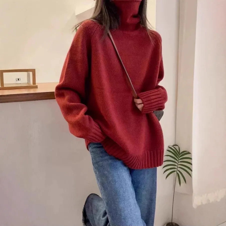 Women's loose thick turtleneck sweater with a curled pile collar in a solid colour.
