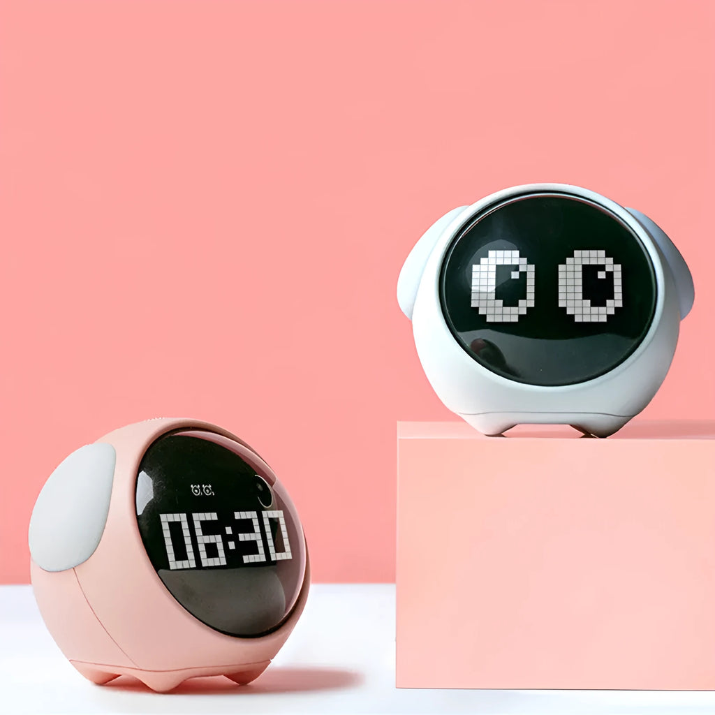 Digital alarm clock with pixel expression display, wake-up light, two alarms, snooze, in pink or white, 110x105x93mm