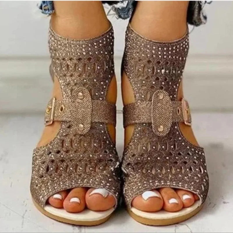 Women's beige wedge sandals with a back zipper and low heel on a white background.
