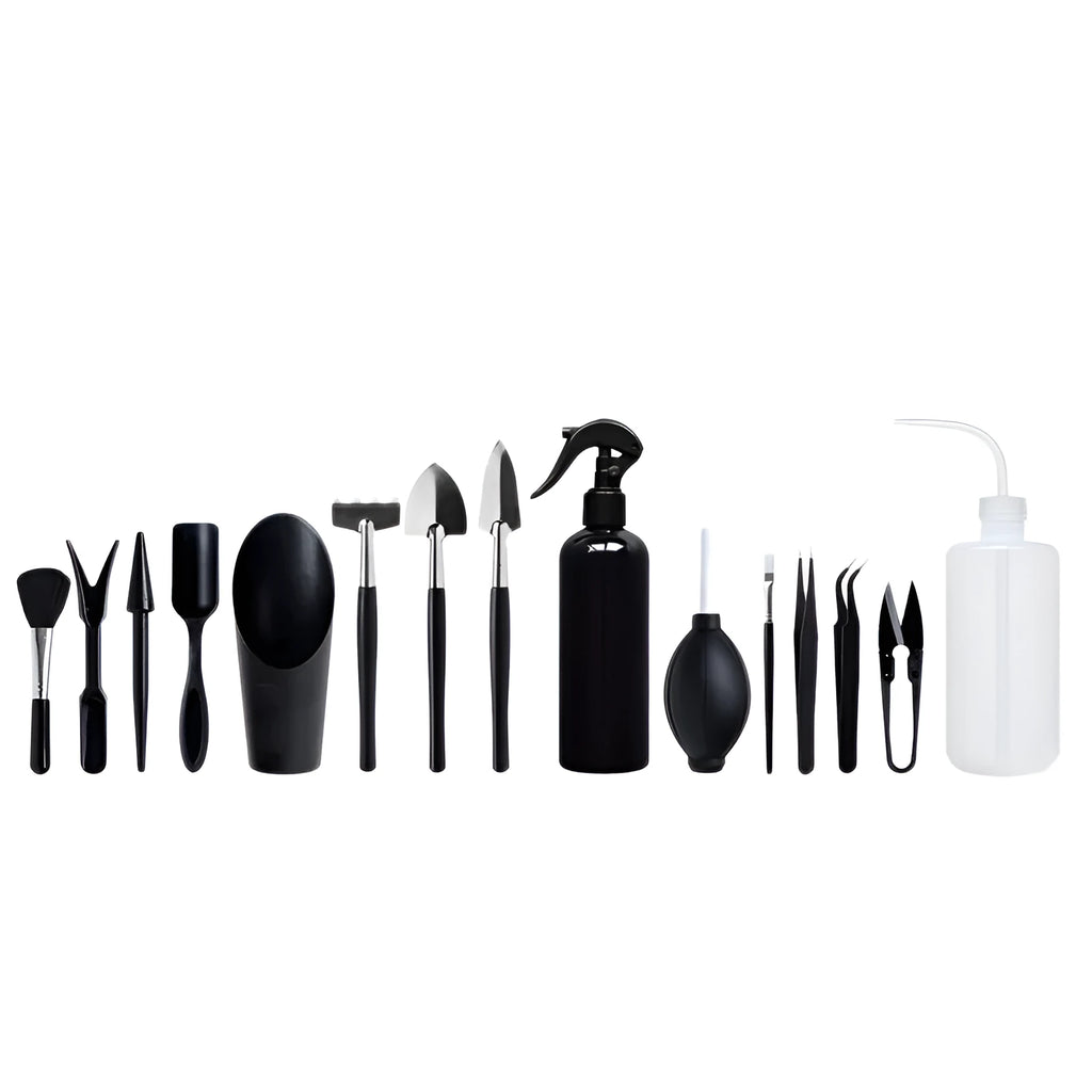 Black mini garden hand tools set including scissors, tweezers, shovels and spray bottle arranged on a cushion for succulent care