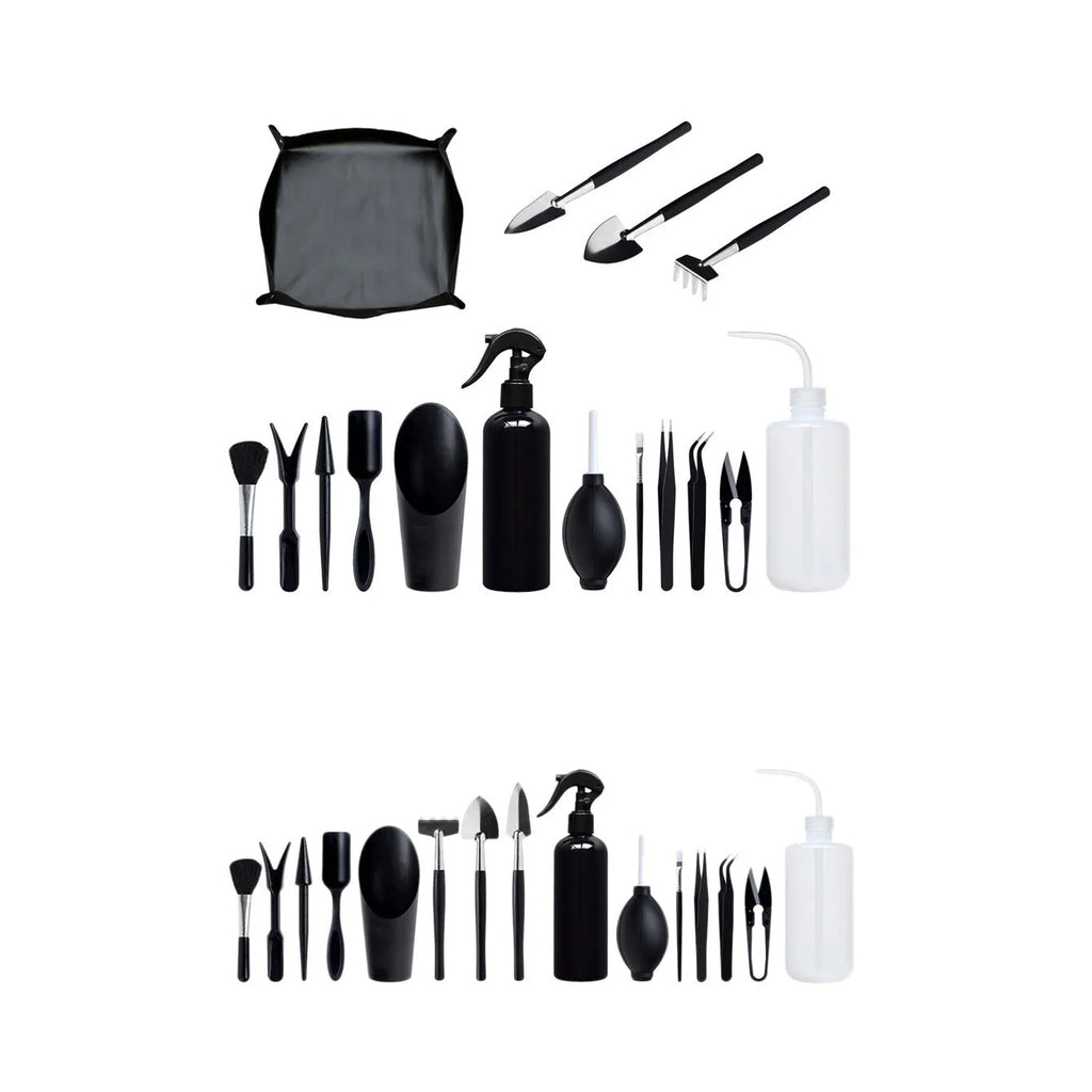 Black mini garden hand tools set including scissors, tweezers, shovels and spray bottle arranged on a cushion for succulent care