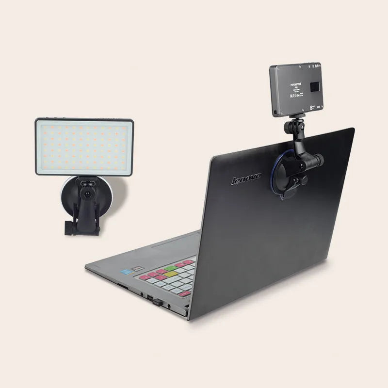 Black aluminium LED video conference light with 96 LEDs and a display screen, shown next to a laptop.