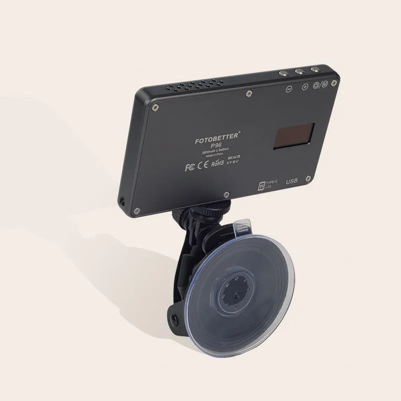 Black aluminium LED video conference light with 96 LEDs and a display screen, shown next to a laptop.