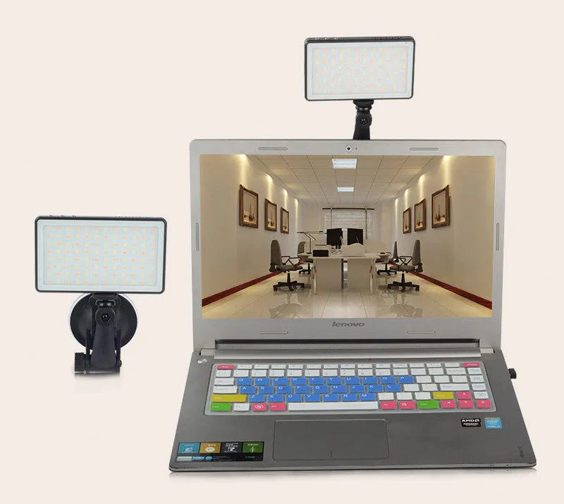 Black aluminium LED video conference light with 96 LEDs and a display screen, shown next to a laptop.