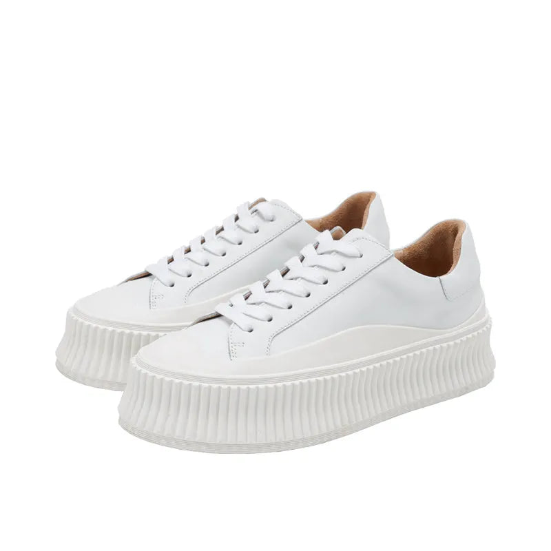 Women's black suede platform sneakers with a thick sole and back lacing system.