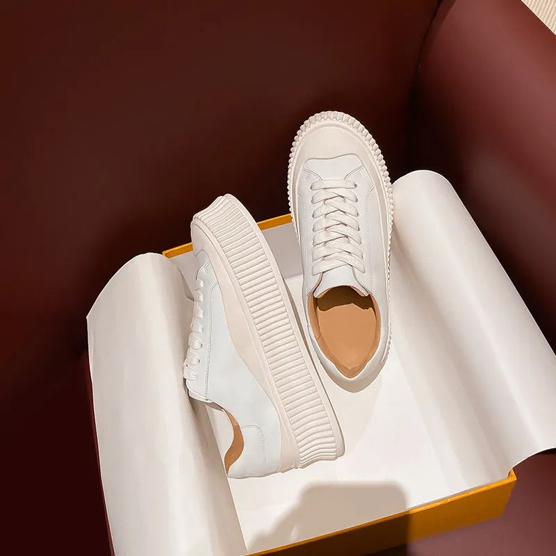 Women's black suede platform sneakers with a thick sole and back lacing system.