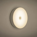 White USB rechargeable motion sensing LED night light with adhesive backing and charging cable