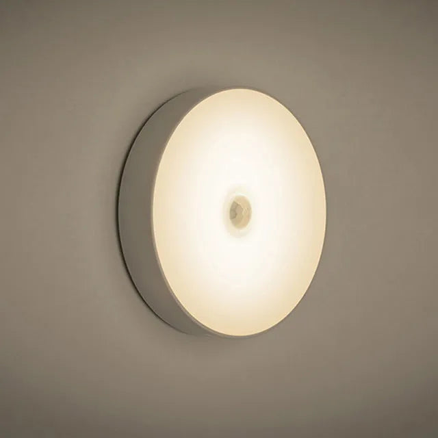White USB rechargeable motion sensing LED night light with adhesive backing and charging cable