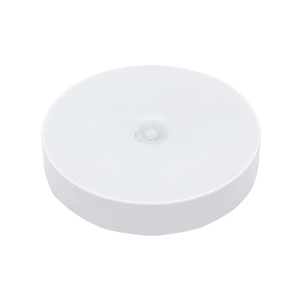 White USB rechargeable motion sensing LED night light with adhesive backing and charging cable
