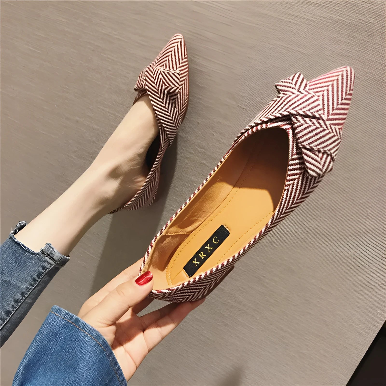Red and black women's pointed toe casual shoes with a low flat heel on a white background.