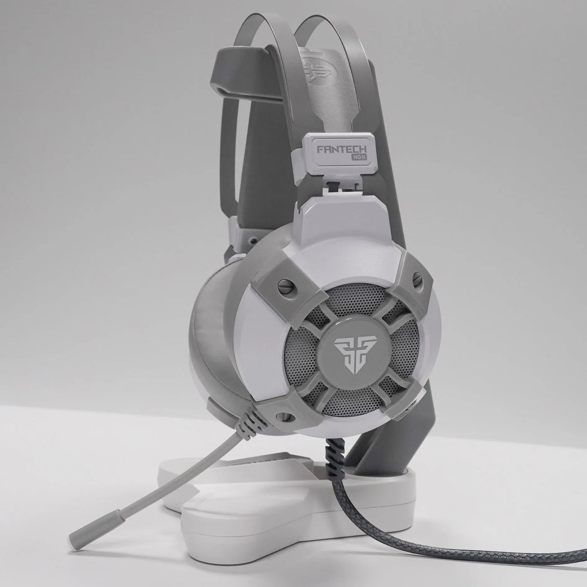 Black FANTECH HG11 gaming headset with RGB lights on ear cups and a retractable microphone.