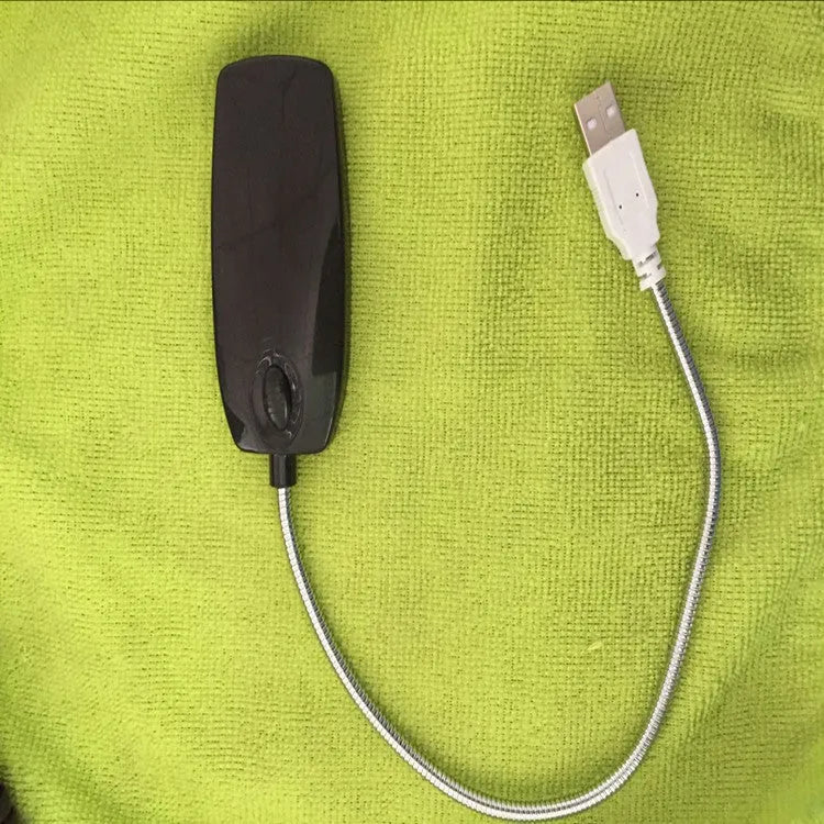 Black USB LED desk lamp with a flexible gooseneck neck bent over a book.