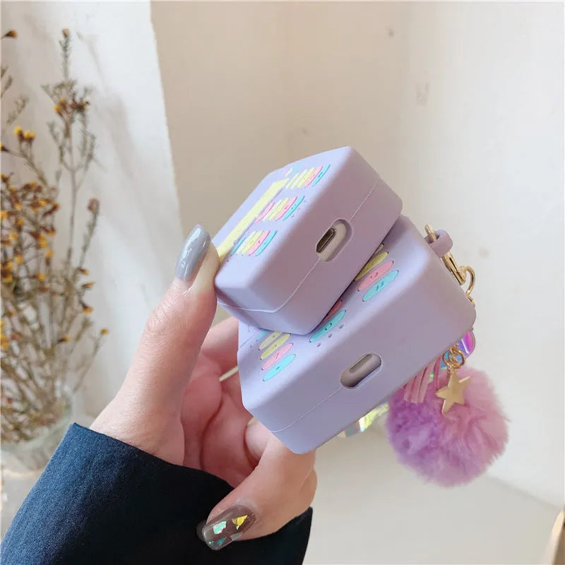 Purple silicone AirPods case with fur ball pendant for wireless Bluetooth headphones