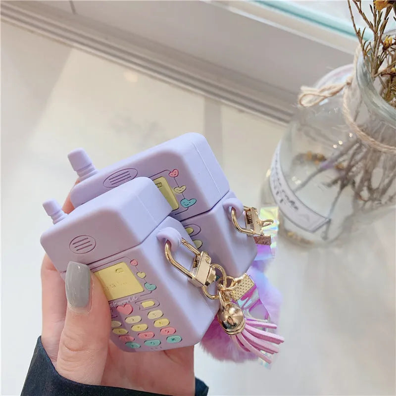 Purple silicone AirPods case with fur ball pendant for wireless Bluetooth headphones