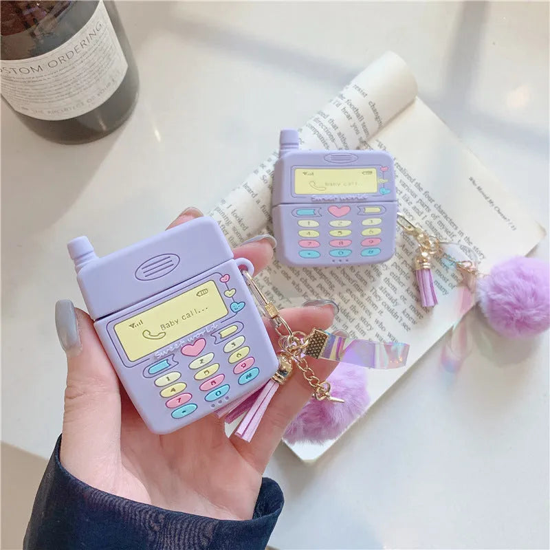 Purple silicone AirPods case with fur ball pendant for wireless Bluetooth headphones